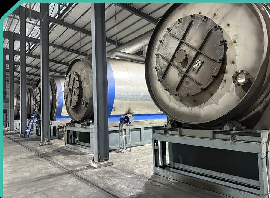 Multiple horizontal batch pyrolysis reactors installed in an industrial workshop